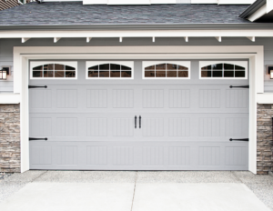 grey garage door with windows and black handles